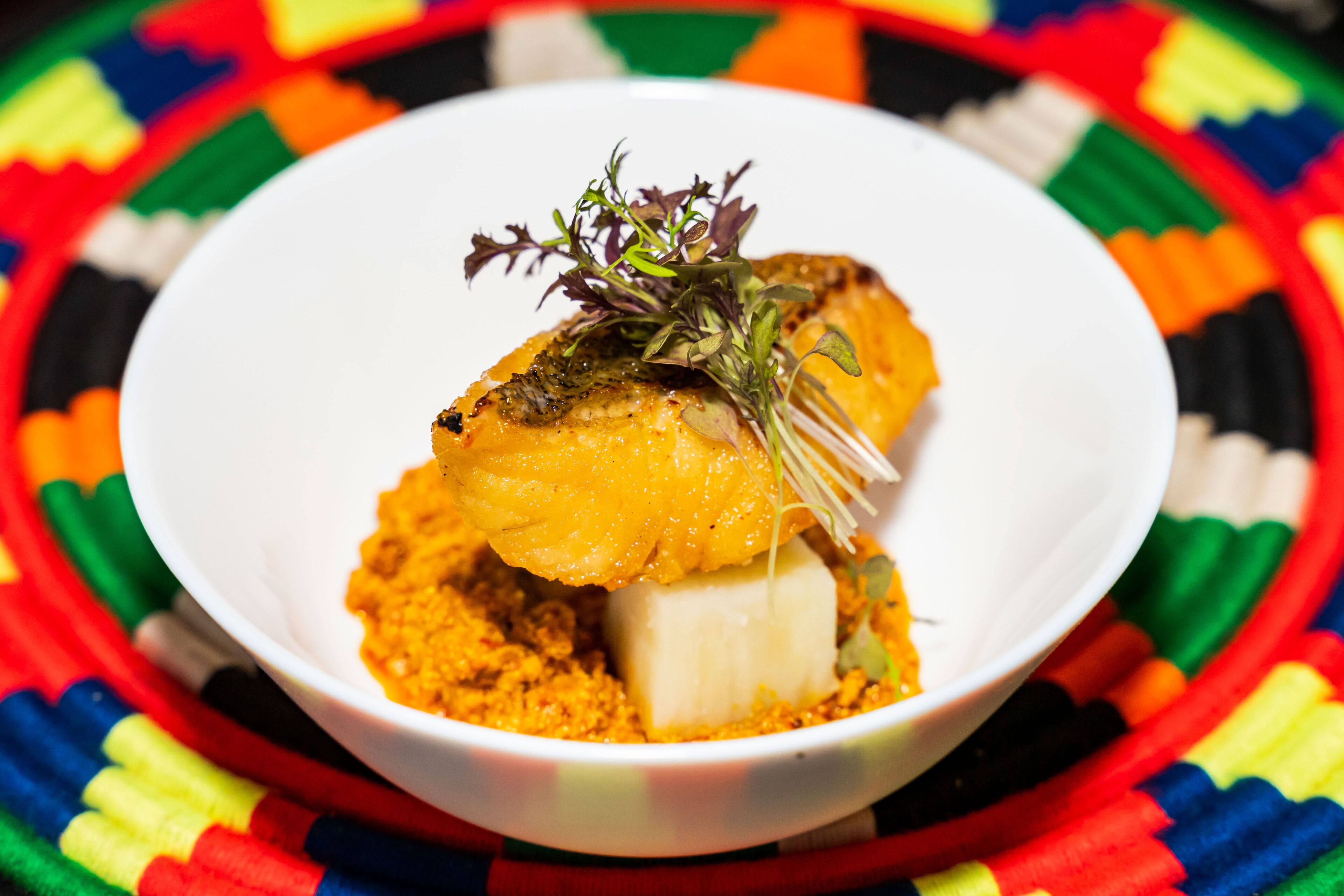 tasty african cuisine in a white bowl on a colourful placemat
