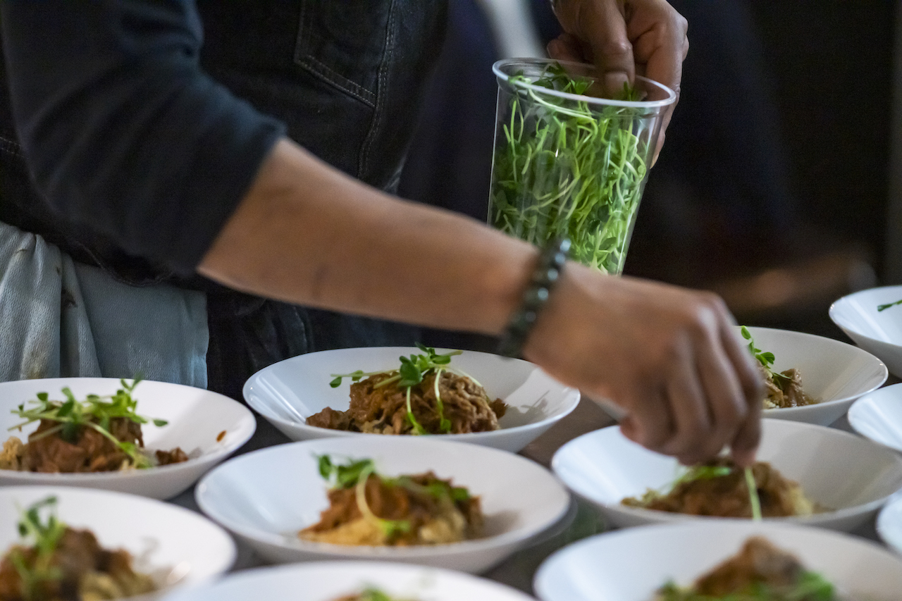 male chef plating tasty African cuisine