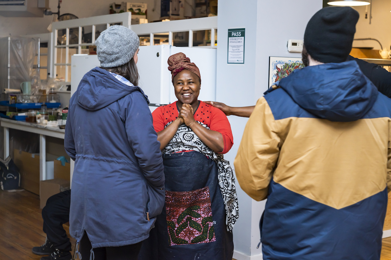 a women chef smiling with her guests