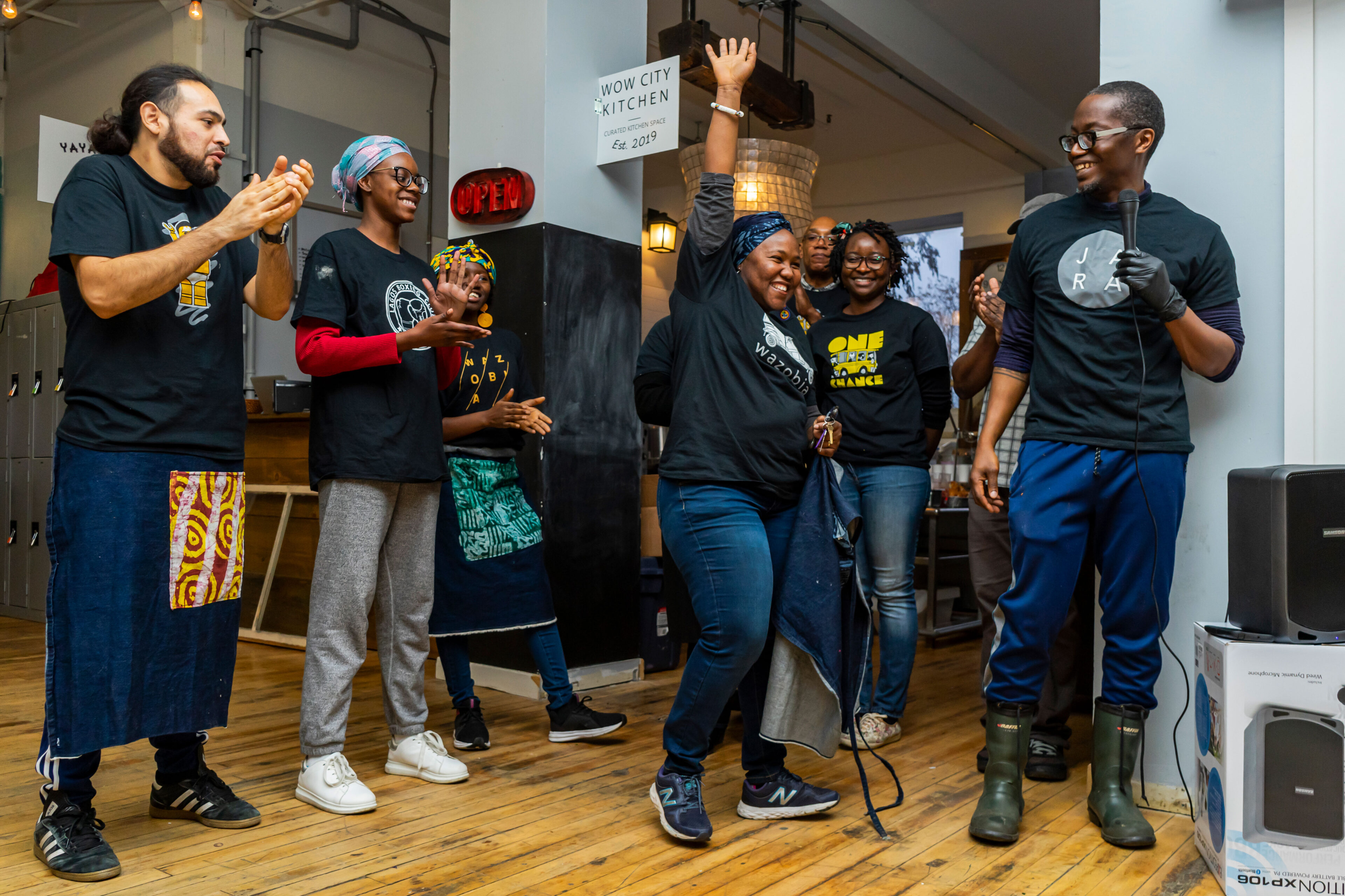 group of people and cooks clapping and celebrating